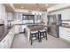 Modern kitchen with white cabinetry, stainless steel appliances, and a granite countertop island at 8373 S Forest Ave, Tempe, AZ 85284