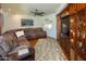 Inviting living room with a plush sectional sofa, hardwood floors, and custom built-in shelving at 8373 S Forest Ave, Tempe, AZ 85284