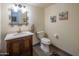 Charming powder room featuring marble countertops, ornate mirror and tiled floors at 8373 S Forest Ave, Tempe, AZ 85284