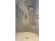 Luxurious shower with multiple showerheads, built-in seat, and tiled surround at 8636 N Farview Dr, Scottsdale, AZ 85258