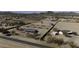 Horse property with covered stalls and a central building, all in a serene desert setting captured from above at 9066 N Thunderbird Rd, Maricopa, AZ 85139
