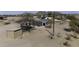 Aerial view of property with house and horse stall coverings with mountain views at 9066 N Thunderbird Rd, Maricopa, AZ 85139