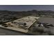 Drone shot of the desert horse property, featuring stalls, a central building, and outlined boundary lines at 9066 N Thunderbird Rd, Maricopa, AZ 85139