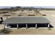 Aerial view showcasing the covered porch and extensive horse stall coverings at 9066 N Thunderbird Rd, Maricopa, AZ 85139
