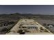 Drone shot of desert horse property, highlighted by boundary lines, covered stalls, and a central building at 9066 N Thunderbird Rd, Maricopa, AZ 85139