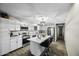 Bright kitchen with white cabinets, stainless steel appliances, island with seating, and modern lighting at 9066 N Thunderbird Rd, Maricopa, AZ 85139