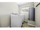 Functional laundry room with modern washer and dryer, plus water heater and ample space at 9066 N Thunderbird Rd, Maricopa, AZ 85139