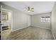 A spacious main bedroom with a fan, tile floors and neutral colors at 9066 N Thunderbird Rd, Maricopa, AZ 85139