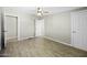 An airy main bedroom features neutral paint, tile floors and fan at 9066 N Thunderbird Rd, Maricopa, AZ 85139
