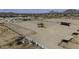 Aerial view of the property, with horse corrals and riding areas, set against a backdrop of mountains at 9066 N Thunderbird Rd, Maricopa, AZ 85139