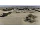 Aerial view of the property with several horse corrals, storage building, and desert landscape at 9066 N Thunderbird Rd, Maricopa, AZ 85139