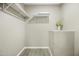 A roomy walk-in closet offering ample storage space, shelves, and a decorative floral accent at 9066 N Thunderbird Rd, Maricopa, AZ 85139
