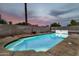 Inviting swimming pool in a private backyard setting surrounded by a block fence and mature trees at 934 S Roslyn Pl, Mesa, AZ 85208