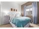Cozy bedroom with a blue blanket and curtains, complemented by neutral walls and furniture at 1225 N 36Th St # 2091, Phoenix, AZ 85008