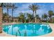 Relaxing community pool with lounge chairs and palm trees offers a resort-like atmosphere at 1225 N 36Th St # 2091, Phoenix, AZ 85008