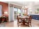 The formal dining room has a wood table with seating for six and sliding glass doors to a balcony at 1225 N 36Th St # 2091, Phoenix, AZ 85008