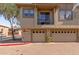 Townhouse featuring dual garages, a small upper balcony, and a neutral stucco exterior at 1225 N 36Th St # 2091, Phoenix, AZ 85008