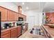 A well-lit kitchen featuring stainless appliances and wood cabinets at 1225 N 36Th St # 2091, Phoenix, AZ 85008