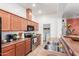 A well-lit kitchen featuring stainless appliances and wood cabinets at 1225 N 36Th St # 2091, Phoenix, AZ 85008