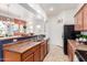 Spacious kitchen with wood cabinets, black appliances, and tile floors at 1225 N 36Th St # 2091, Phoenix, AZ 85008