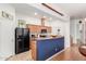 View of kitchen with black appliances, tile flooring, and a wraparound bar at 1225 N 36Th St # 2091, Phoenix, AZ 85008
