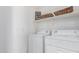 Clean laundry room with a modern washer and dryer, and organized shelving above at 1225 N 36Th St # 2091, Phoenix, AZ 85008