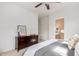Bright main bedroom with ensuite bathroom access, dark wood dresser, and a ceiling fan at 1225 N 36Th St # 2091, Phoenix, AZ 85008