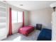Bright bedroom featuring two twin beds, red curtains, and neutral walls at 1349 E Dunbar Dr, Phoenix, AZ 85042