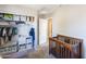 Bedroom/bedroom with a baby crib, shelving, and a well-organized closet at 1349 E Dunbar Dr, Phoenix, AZ 85042