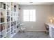 Bright bedroom with plush carpet, large built-in shelving, and a quaint rocking chair by the window at 1349 E Dunbar Dr, Phoenix, AZ 85042