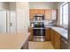 Well-equipped kitchen features stainless steel appliances, light wood cabinetry and a sink with a view at 1349 E Dunbar Dr, Phoenix, AZ 85042