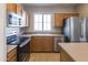 Bright kitchen boasts stainless steel appliances and ample counter space for meal preparation at 1349 E Dunbar Dr, Phoenix, AZ 85042