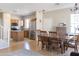Bright living room with dining area, hardwood floors, stainless steel refrigerator, and staircase at 1349 E Dunbar Dr, Phoenix, AZ 85042
