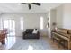 Bright living room with modern furniture, hardwood floors, piano, and outdoor access at 1349 E Dunbar Dr, Phoenix, AZ 85042