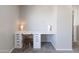 Functional office space featuring a long white desk with drawers and a neutral color palette at 1349 E Dunbar Dr, Phoenix, AZ 85042
