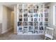 Comfortable reading nook features a white rocking chair and floor-to-ceiling bookshelves at 1349 E Dunbar Dr, Phoenix, AZ 85042