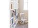 Charming reading nook with a white rocking chair and wall-to-wall bookshelves at 1349 E Dunbar Dr, Phoenix, AZ 85042