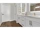 Bathroom with double sinks, quartz countertop, modern fixtures, and wood floors at 1366 W Santa Gertrudis Trl, San Tan Valley, AZ 85143