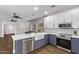 Modern kitchen featuring two-tone cabinets, stainless steel appliances, and a farmhouse sink at 1366 W Santa Gertrudis Trl, San Tan Valley, AZ 85143