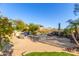 Spacious backyard featuring a covered outdoor living space with beautiful landscaping and natural light at 15827 E Firerock County Club Dr, Fountain Hills, AZ 85268