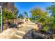 Beautiful backyard waterfall feature with stone steps and lush greenery at 15827 E Firerock County Club Dr, Fountain Hills, AZ 85268