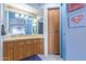 Well-lit ' bathroom featuring custom wood cabinetry and blue accent walls at 15827 E Firerock County Club Dr, Fountain Hills, AZ 85268