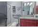 Well-lit bathroom features a glass enclosed shower, a white toilet, and custom shelving at 15827 E Firerock County Club Dr, Fountain Hills, AZ 85268