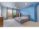 Comfortable bedroom features a ceiling fan, an outdoor balcony, and soft, neutral carpet at 15827 E Firerock County Club Dr, Fountain Hills, AZ 85268