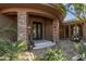 Elegant front entrance features stone columns, decorative doors, and lush landscaping at 15827 E Firerock County Club Dr, Fountain Hills, AZ 85268