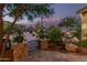 Charming gated entrance with stone pillars opens to a beautifully landscaped yard with desert vegetation at 15827 E Firerock County Club Dr, Fountain Hills, AZ 85268