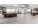 Open-concept living area featuring a stone fireplace, modern lighting, and seamless access to the outdoor spaces at 15827 E Firerock County Club Dr, Fountain Hills, AZ 85268