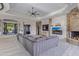Spacious living area features a stone fireplace, large sectional, and modern entertainment setup at 15827 E Firerock County Club Dr, Fountain Hills, AZ 85268
