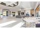 Open living space with stone fireplace, bar, and seamless transition to the outdoor landscape at 15827 E Firerock County Club Dr, Fountain Hills, AZ 85268