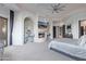Airy bedroom suite with a fireplace, ceiling fan, and neutral decor offers a luxurious and relaxing space at 15827 E Firerock County Club Dr, Fountain Hills, AZ 85268